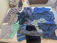 All garments laid out on bed showing colours and styles
