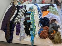 All scarves and wraps laid out on bed