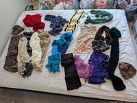Overall view of all scarves and hats spread on bed
