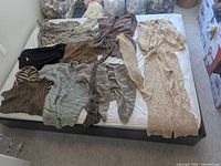 All knitwear pieces laid out on bed