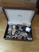Closed brown Deux Voix watch box filled with multiple wristwatches