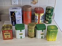 group shot showing eight of nine assorted Chinese tea tins