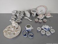 Overview of assorted miniature porcelain tea sets and tableware