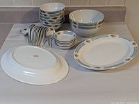 All dinnerware pieces grouped: platters, bowls, spoons, dishes