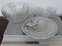 Full lot showing punch bowl, cups, Lazy Susan tray with lid and ruler for scale