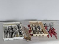 Overall lot with two plastic cutlery trays, red-handled flatware, bamboo chopsticks and tea strainers