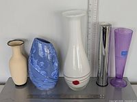 Group view of all five pieces with rulers indicating scale