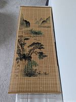 Full view of one scroll showing bamboo construction and painted landscape
