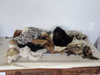 Pile of assorted fur stoles and trims on table