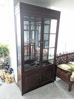 Full view of rosewood glass curio cabinet