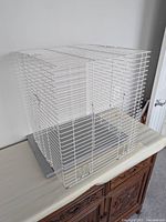 three-quarter view of bird cage on a surface