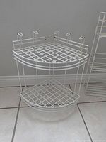 2-tier white metal wire corner shelf showing overall design and condition