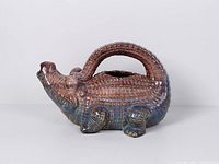 Left side view of alligator-shaped ceramic pitcher
