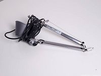 Entire lamp arm and shade coiled for display