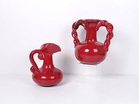 Both red ceramic pieces side by side