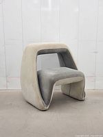 Front view of sculptural two-tone suede chair