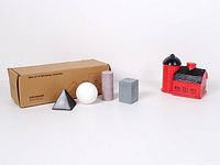 Box labeled "Set of 4 Whiskey Stones" with four geometric stones and red barn with silo shakers