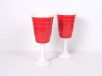 Full view of both ceramic red cup wine glasses