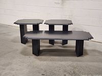 Three black Art Deco tables front view