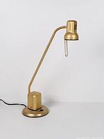 Full view of brass metal adjustable table lamp