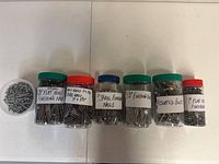 Front view showing all seven labeled jars with contents visible