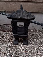 Front view of assembled black cast concrete pagoda lantern