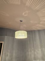 Chandelier lit, full view from below, shows shade and light pattern on ceiling