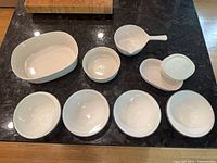 Top view of all 10 white CorningWare pieces laid out on countertop