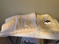 Both electric blankets folded on table with controllers attached