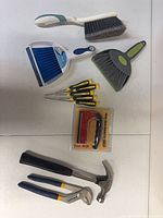 All items laid out showing magnetic sweep in packaging, hand tools, dustpan set and brushes