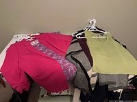 Overall view showing pink blazer, paisley shell, lime top, colour-block cardigan