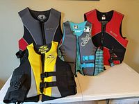 Front view of four life jackets standing upright