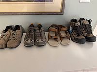 Four pairs footwear on shelf; shows overall lot