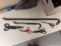 All tools laid out showing two pry bars and four cutting tools