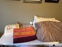 Full lot showing pillows, towels and pillowcases
