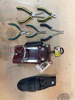 Front view showing hammer holder, four pliers, nylon sheath