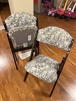 Two folding upholstered chairs front view showing pattern and overall design
