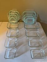 Nesting arrangement of glass containers and matching lids