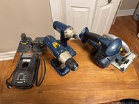 Group shot of all Ryobi 18V tools, batteries and charger on table