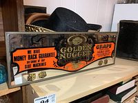 Full view of Golden Nugget mirrored bar sign on shelf