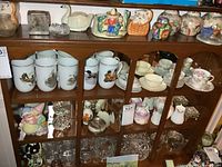Full view of cabinet showing ceramics, mugs, glassware and trinket boxes