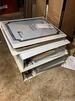 Stack of three white binders filled with comics