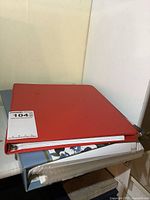 Red binder stacked on blue binder