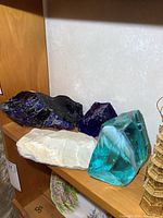 Group of glass chunks and rock on shelf