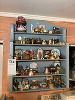 Front view of blue shelf filled with miniature items