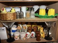 Two-shelf cabinet view showing most of the salt & pepper shaker pairs