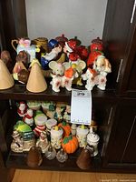 Overview of two shelves filled with assorted salt and pepper shakers