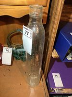 Full view of tall clear Shell glass bottle