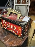 Side view showing painted "Shine" lettering and overall box condition