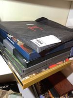 Stack of six Canada Post stamp yearbooks in assorted coloured slipcases